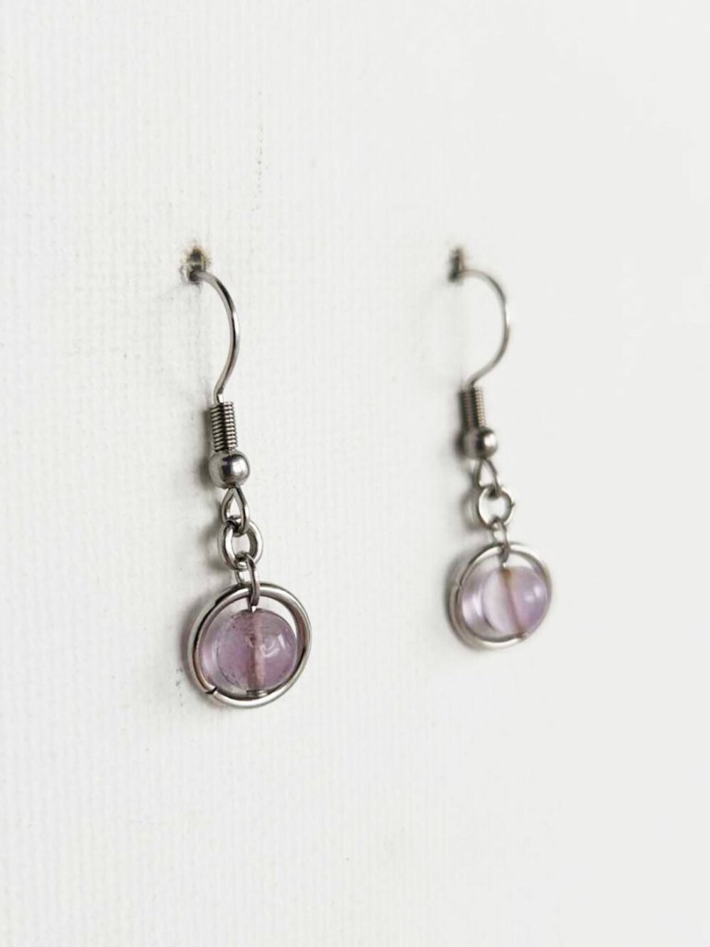 Silver and purple dangly earrings
